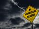 Hurricane season with symbol sign against a stormy background and copy space. Dirty and angled sign adds to the drama.
