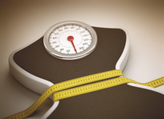 Tape Measure Around The Balance Decreasing Its Measures.