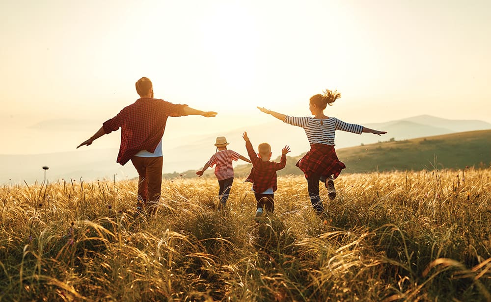 Happy Family: Mother, Father, Children Son And Daughter On Sunset