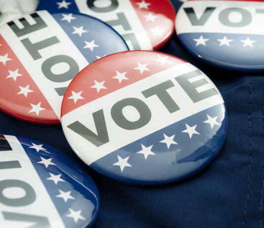 Democrat Vs Republican Poll, Democratic Decision And Primary Voting Conceptual Idea With Vote Election Campaign Button Badges And The United States Of American Flag