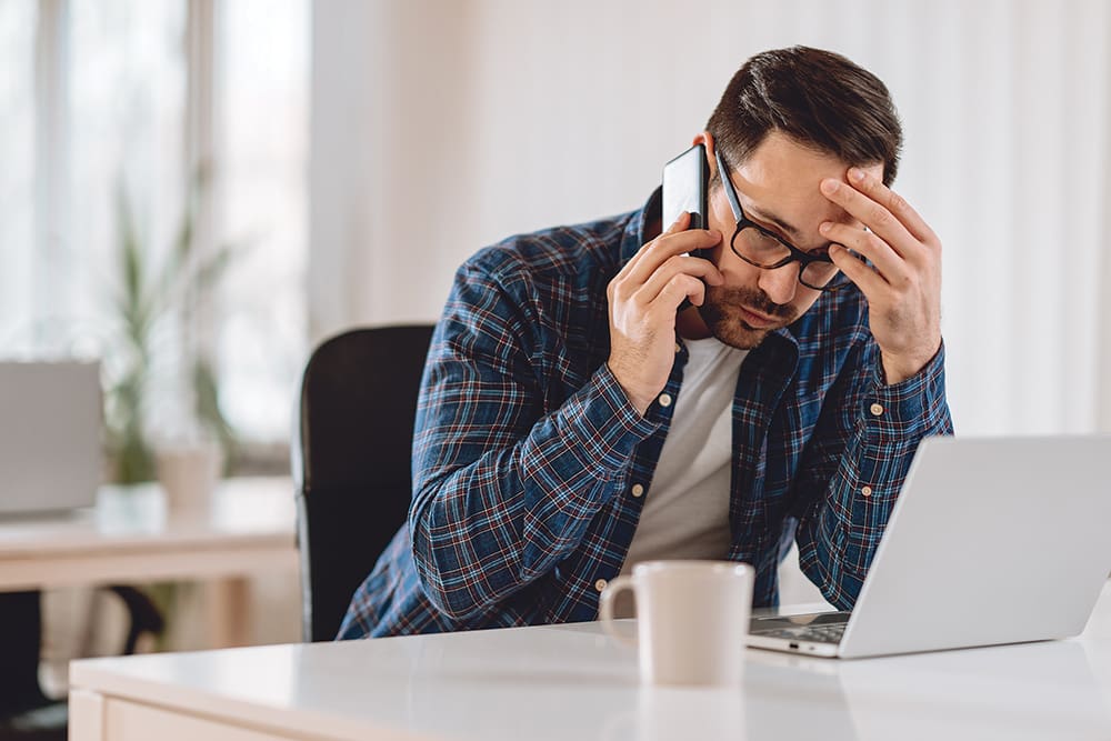 Worried Businessman Talking On Phone