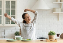 Happy Millennial Woman Have Fun Cooking Breakfast In Kitchen