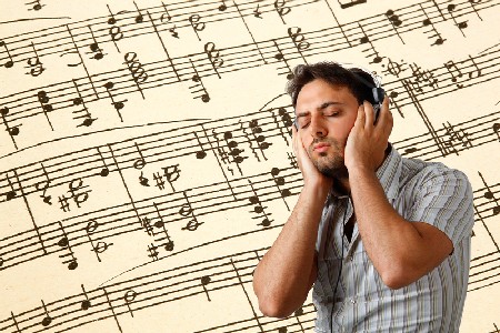 Young Man Listens To Music With Headphones