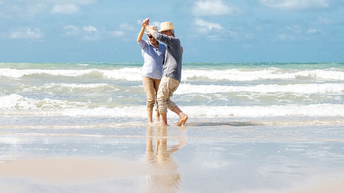 Asian Senior Couple Dancing On The Beach